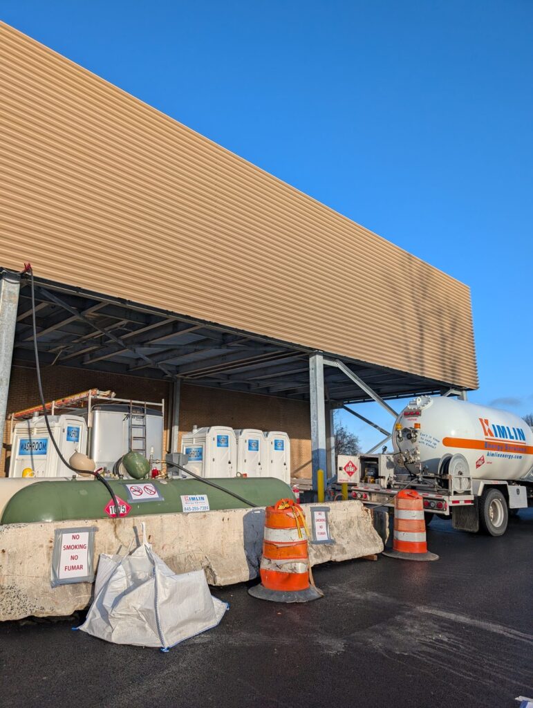 Kimlin Energy temporary heat propane tank behind concrete barriers at a Westchester County construction site