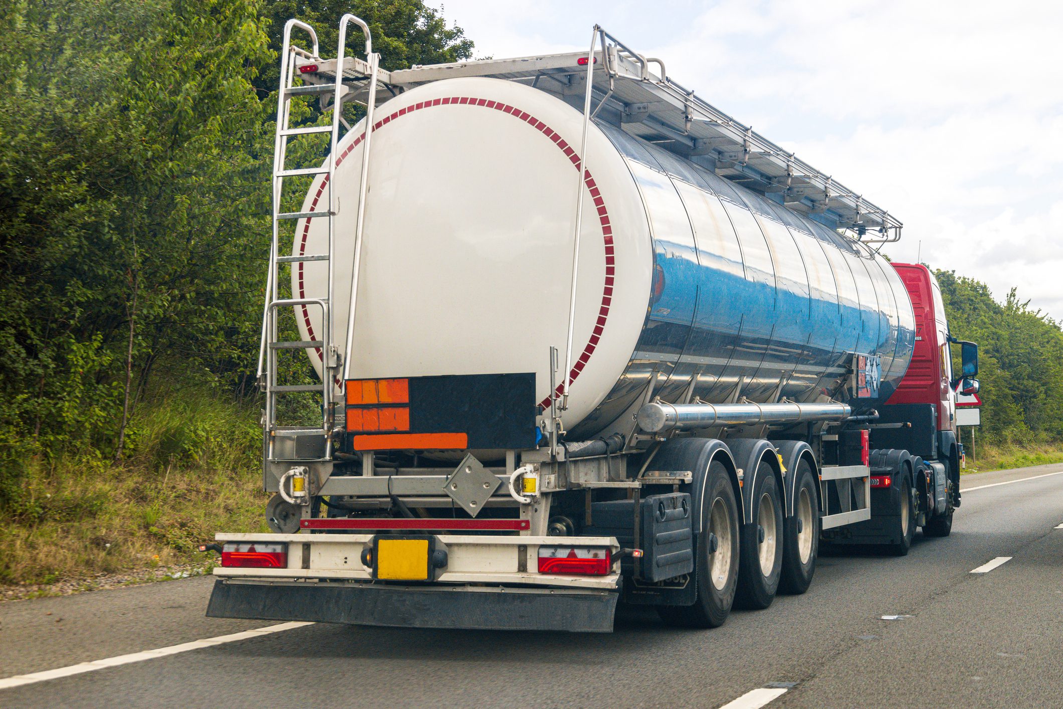 A fuel tanker traveling along a motorway in the United Kingdom