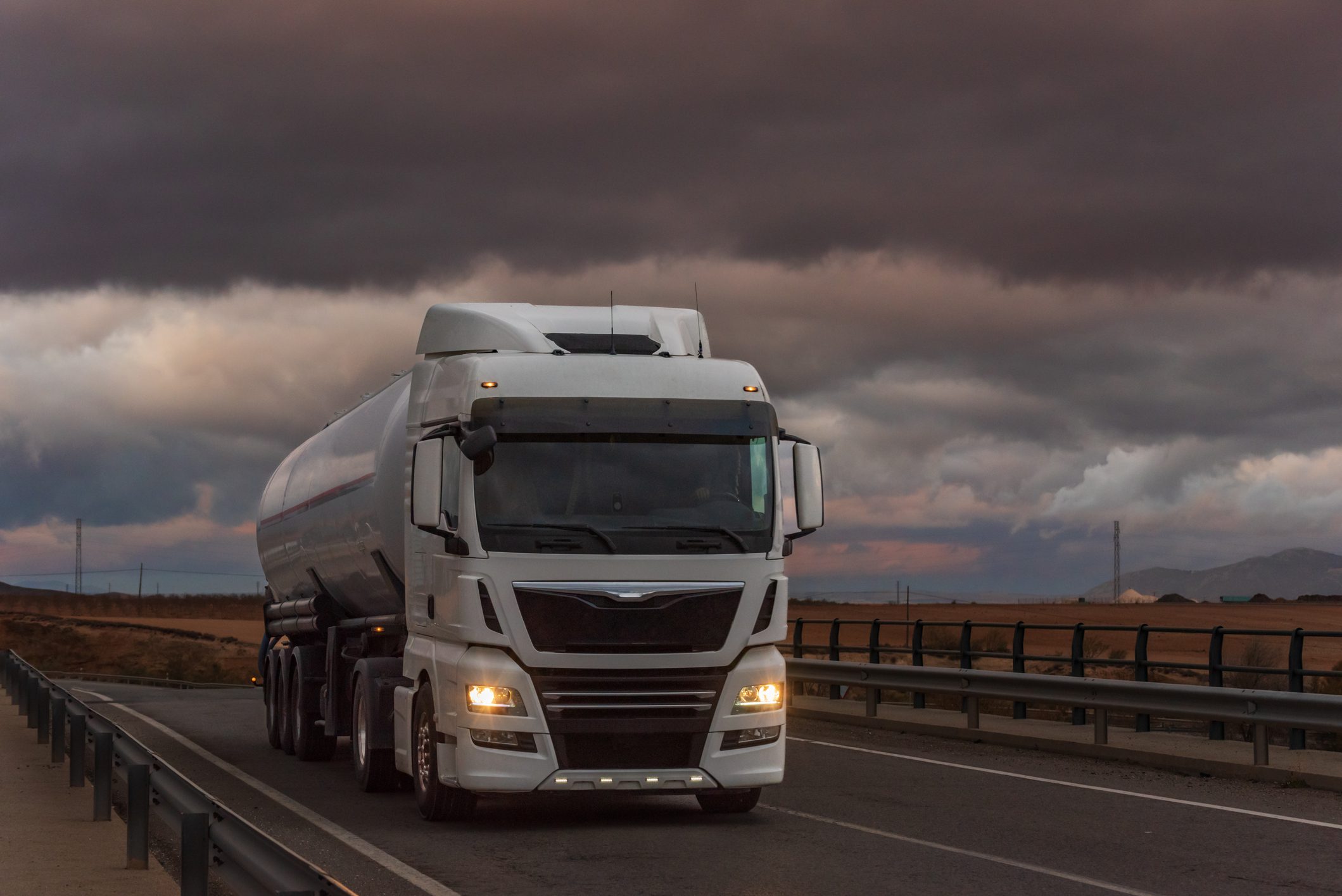 Truck with silo semi-trailer for the transport of powders at sunset.