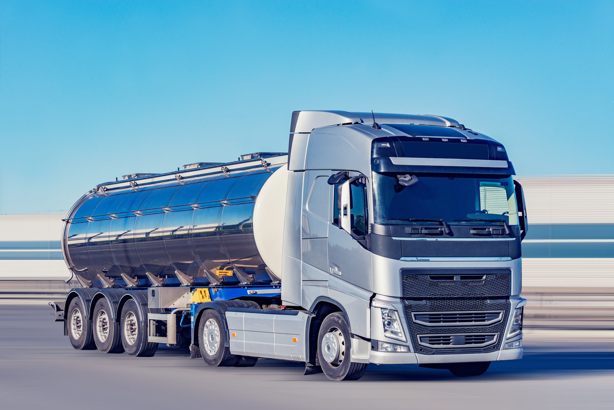 Freight truck with tank moves on the highway.