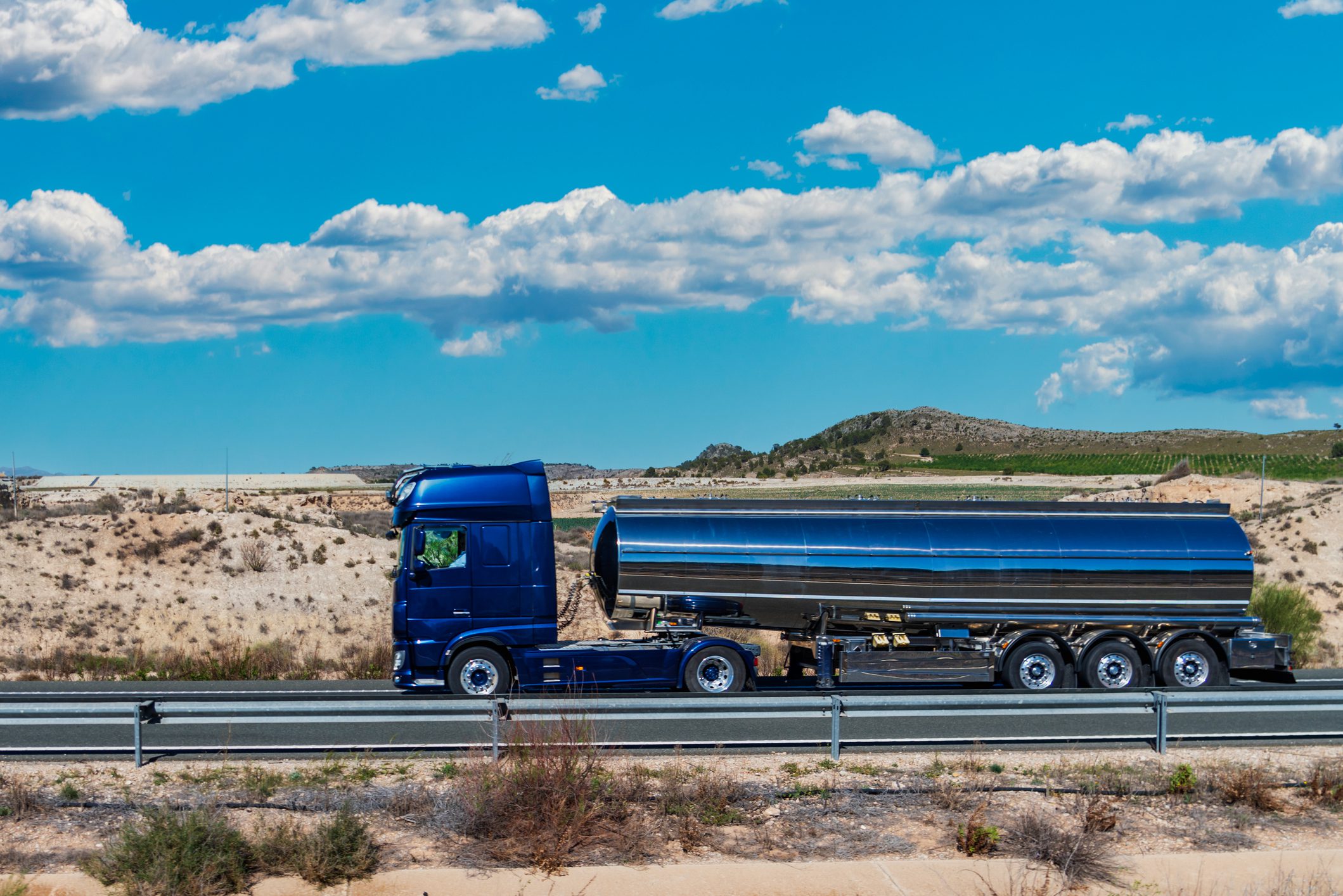 Tanker truck for transporting food liquids traveling on a highway.