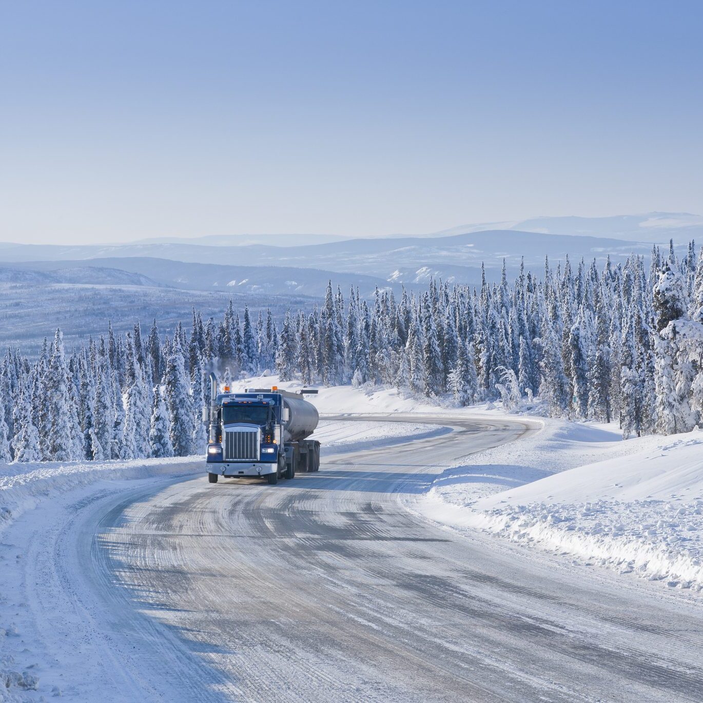 Big Rig Semi-Truck driving on an Icy Arctic Winter Highway in Alaska