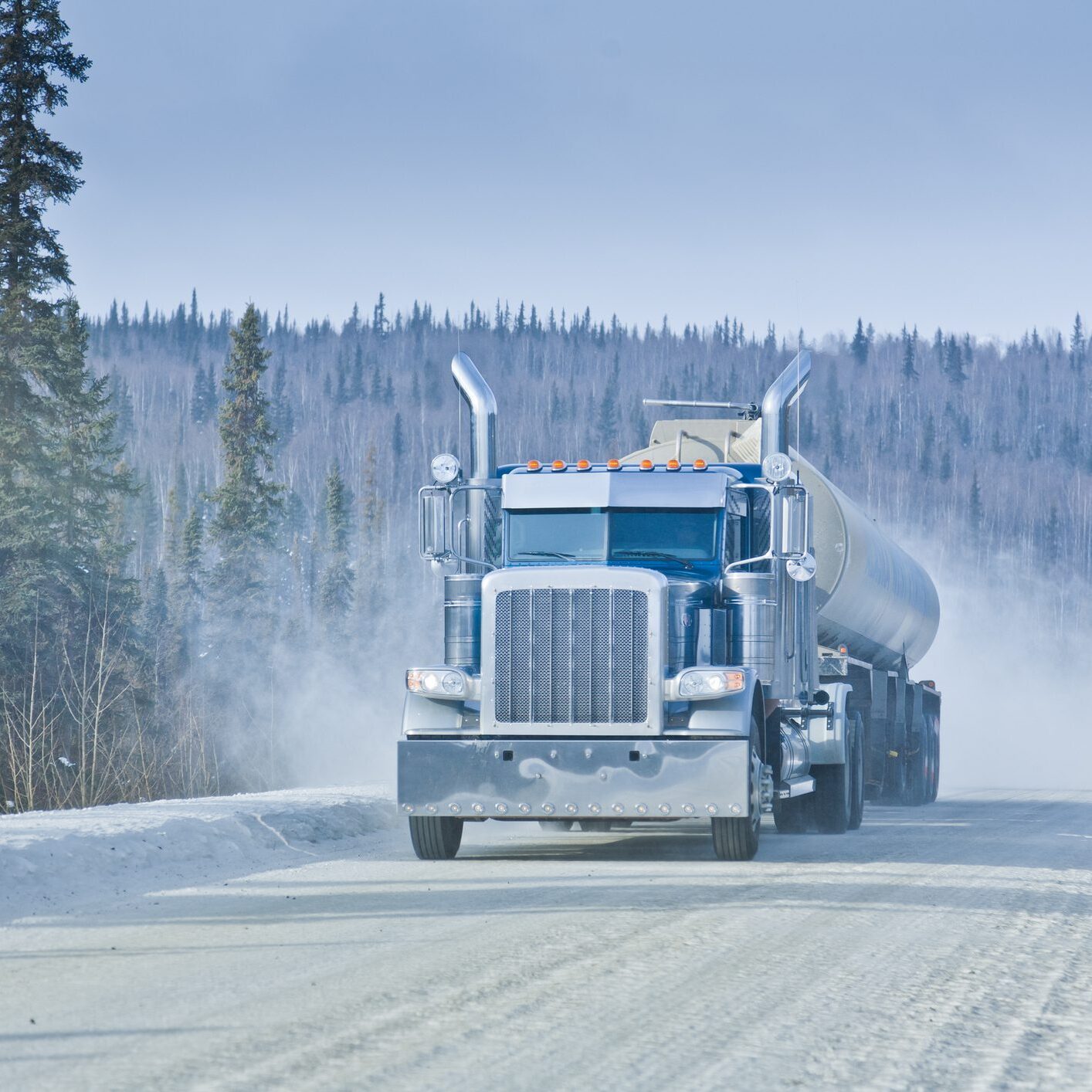 Big Rig Semi-Truck driving on an Arctic Winter Highway in Alaska